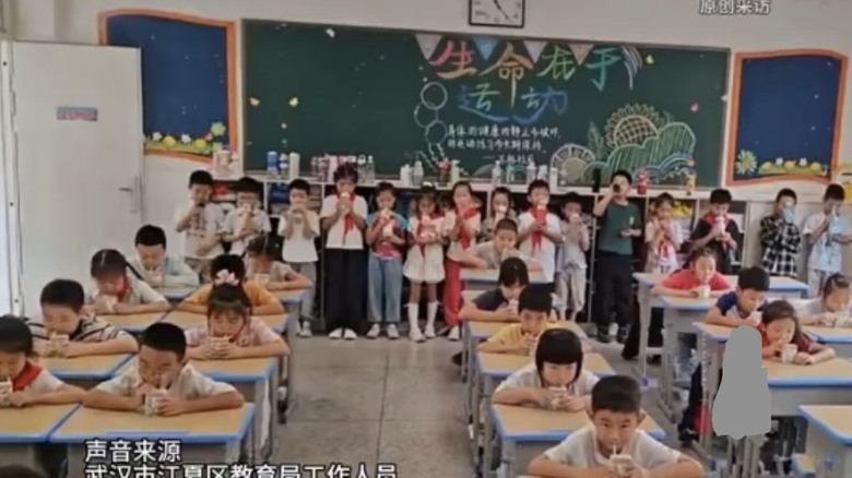 點我看大圖 訂奶生坐著喝奶, 沒訂的站著喝水, 武漢江夏區教育局謊稱後者是剛好在拿水🤥